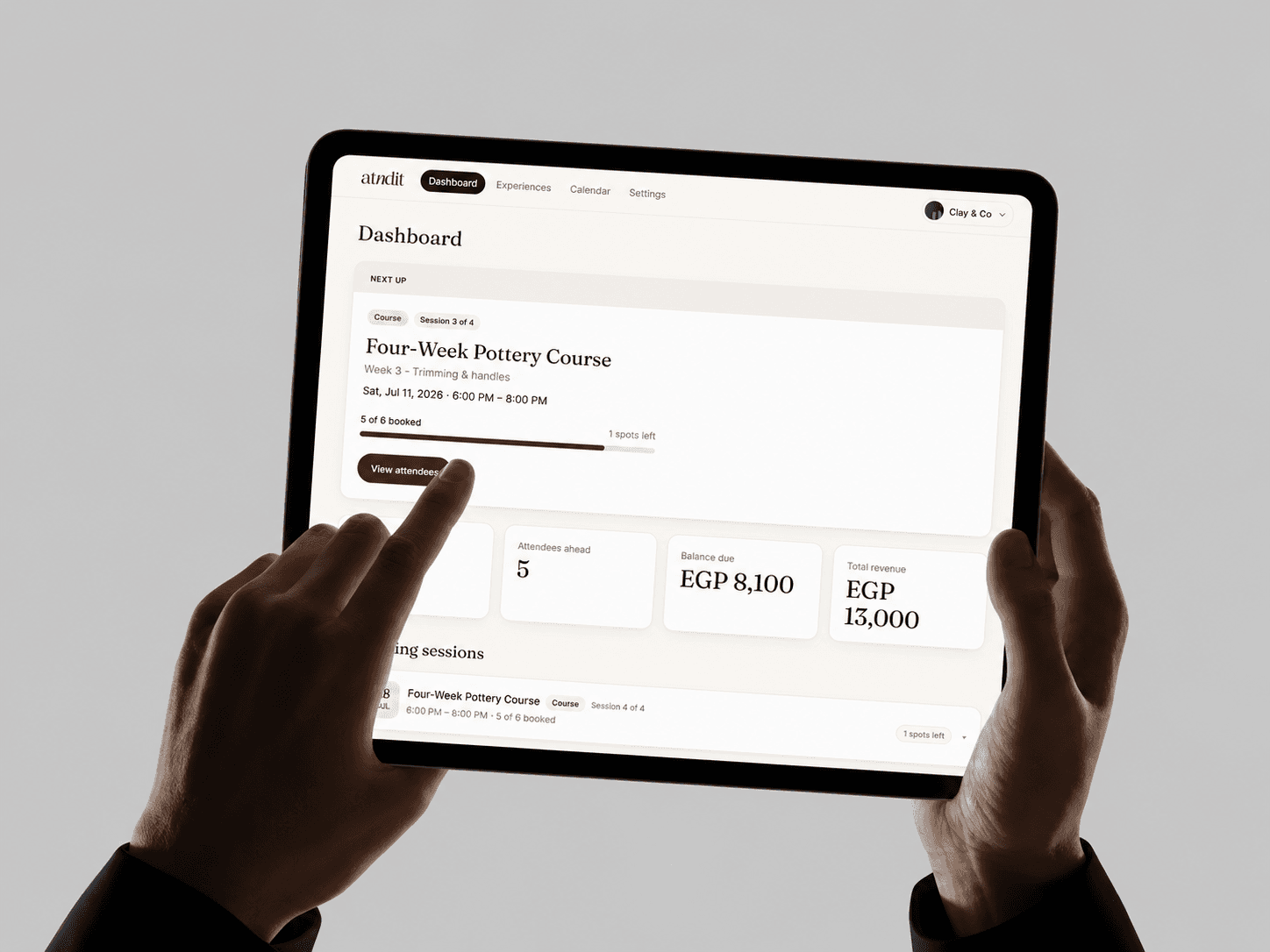 The atndit host dashboard on an iPad, showing upcoming sessions, bookings, and revenue.